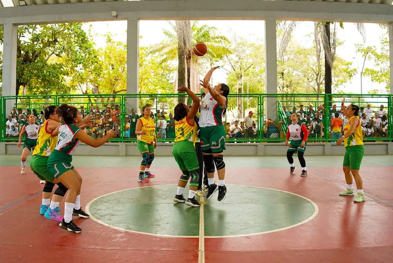 Jugadoras de baloncesto disputando un rebote bajo techo